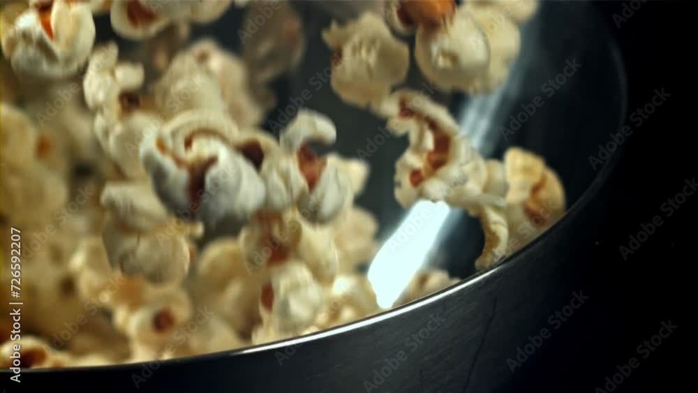 Poster popcorn drops into a big bowl. filmed on a high-speed camera at 1000 fps. high quality fullhd footag