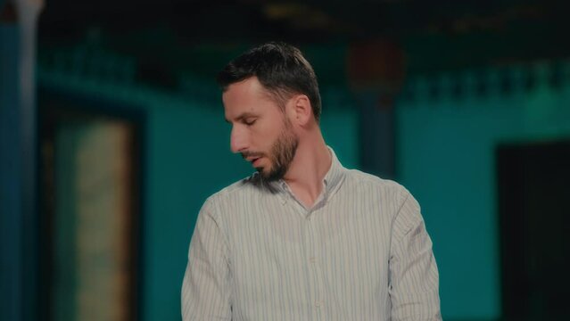 Frontal Shot of a Muslim Man Turning Head Right and Left Ending Islamic Prayer