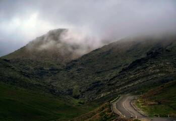 winding road in gloomy foggy rocky mountains. Dark Pass in Karatau mountains in Southern Kazakhstan