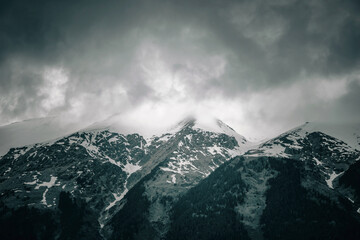 Obraz premium Beautiful mountain landscape. Clouds in the sky. Green grass. Snow on mountain peaks.