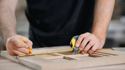 Banner DIY carpentry workshop industry. Closeup of craftsman hand making wooden facade of handmade kitchen furniture - obrazy, fototapety, plakaty