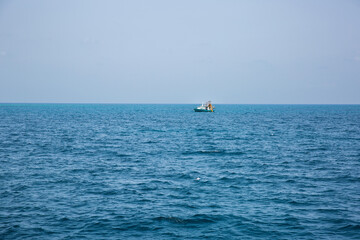distant fishing trawler on the pacific ocean