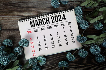 March 2024 monthly calendar with flower bouquet decoration  on wooden background