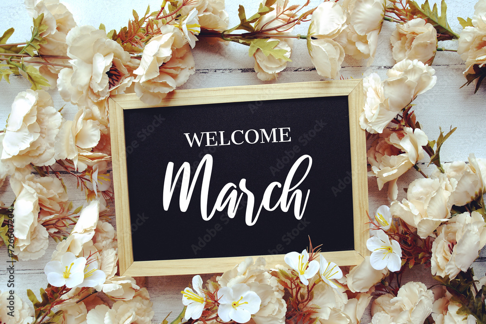 Sticker Welcome March text message with flower decoration on wooden background