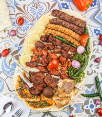 Assorted mix grills with tikka boti seekh kabab of lamb chops, pita bread, flafel, chicken, beef,...