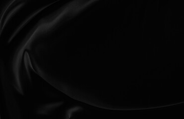 Black gray satin dark fabric texture luxurious shiny that is abstract silk cloth background with patterns soft waves blur beautiful.