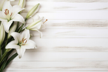 composition of white lilies on a light wooden background 