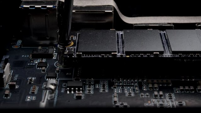 Screwing MSATA nvme M2 with a screwdriver for connecting fast modern SSD. High quality photo