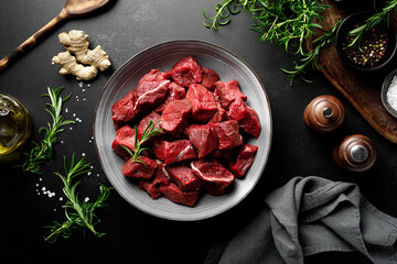 Beef meat entrecote sliced, raw beef meat fillet on black background, top view