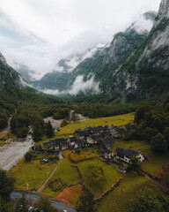 Sonogno village in Swiss alps with waterfall nearby.