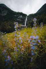 Sonogno village in Swiss alps with waterfall nearby.