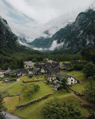 Sonogno village in Swiss alps with waterfall nearby. - obrazy, fototapety, plakaty