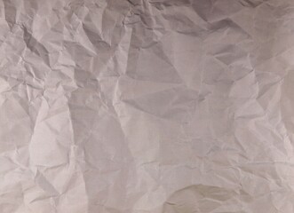 A heterogeneous background of gray material crumpled in folds.