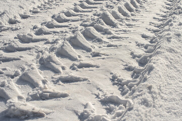 Tire tracks on the road covered with snow