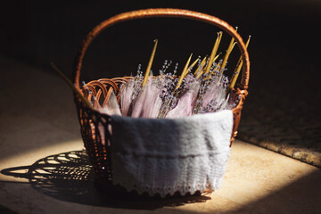 A basket with candles decorated with lavender bouquets in the Church. Accessories for an Orthodox...