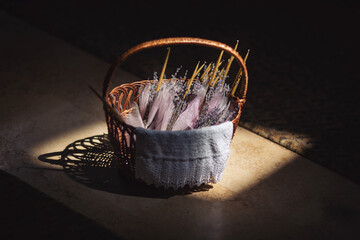 A basket with candles decorated with lavender bouquets in the Church. Accessories for an Orthodox...