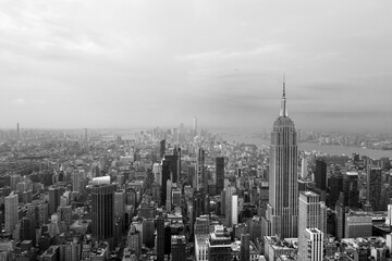 Black and white view of New York City skyline looking down past the Empire State Building towards...