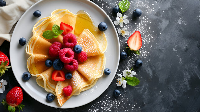 Traditional breakfast homemade thin pancakes with fresh berries and honey on a dark concrete background, top view with space for text. Maslenitsa concept