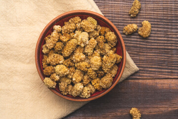 Dried white mulberry on wooden background