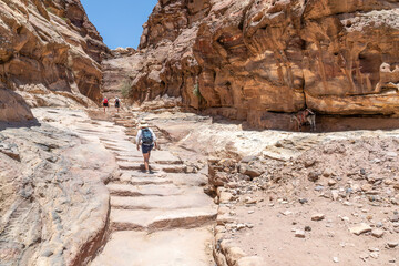 Petra, Jordan - Hikers on the path to the Monastery in Petra, Jordan