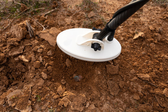 Closeup Waterproof Metal Gold Detector, White Coil above Soil Pit and Old Coins. Excavation, Search for Treasure Or Ancient Things. Archeology, Minesweeper. Horizontal Nobody