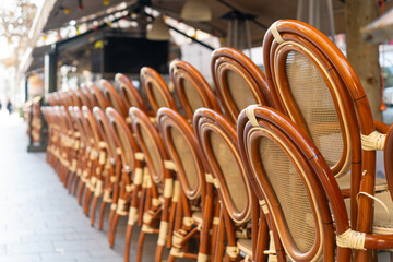 Rows of brown chairs on the street terrace of a cafe on a street in Budapest