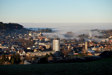 Obraz premium Stunning view of saint gallen with fog in the backround. Autumn morning dust and the silberturm in the middle. 