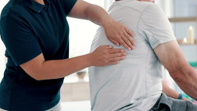Physical therapy, back massage and chiropractor with elderly man in medical office at clinic. Rehabilitation, patient and closeup of physiotherapist helping senior male person healing muscle pain.