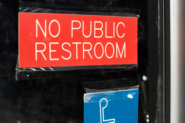 No Public Restroom sign posted on the door at a restaurant.