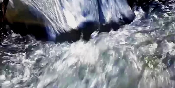 clear and natural river water flowing in rural nature