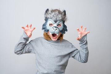 The roar of a wolf, isolated on a gray background. Early child development and imagination
