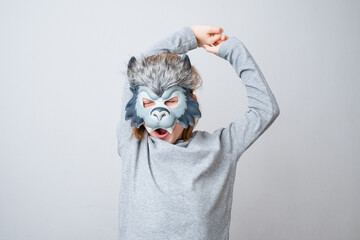 The sleepy wolf stretching, isolated on a gray background. Early child development and imagination....