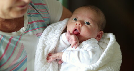 Holding newborn baby infant first month old of life