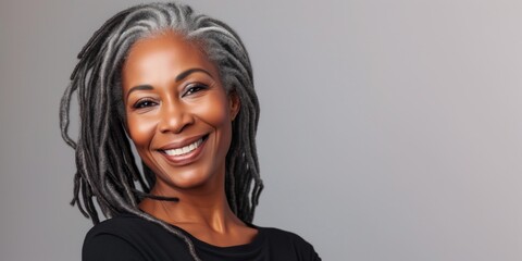 Beautiful elegant mature grey haired middle aged African American woman with perfect skin and smile