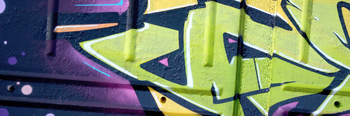 Colorful background of graffiti painting artwork with bright aerosol outlines on wall. Old school...