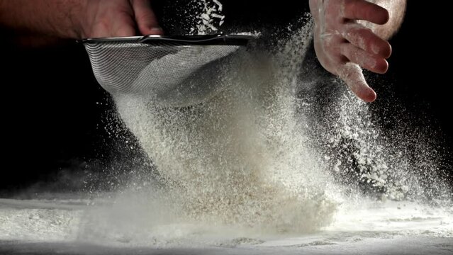 The cook sifts the flour. Filmed on a high-speed camera at 1000 fps. High quality FullHD footage