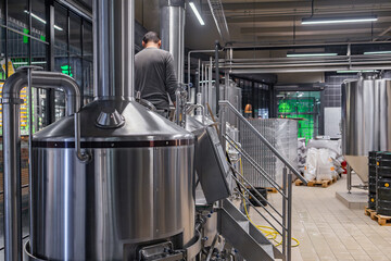 Brewery worker monitoring fermentation