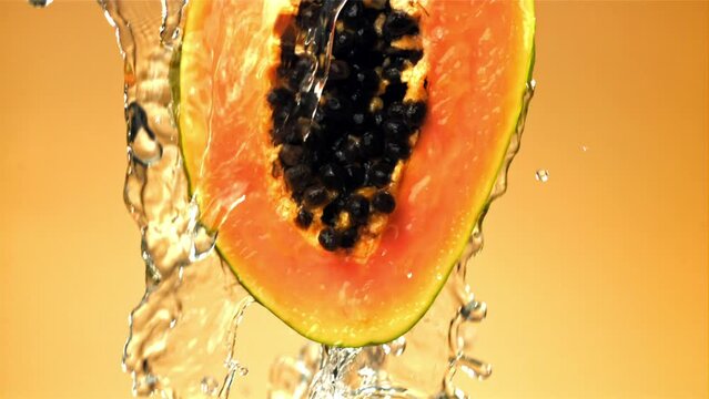 Fresh tropical papaya with drops and splashes of water. Filmed on a high-speed camera at 1000 fps. High quality FullHD footage
