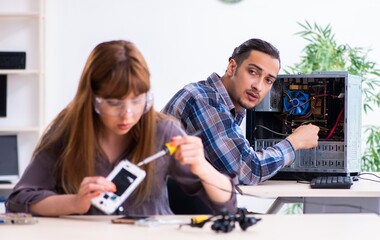 Two technicians working at computer warranty center