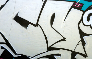 Colorful background of graffiti painting artwork with bright aerosol outlines on wall. Old school street art piece made with aerosol spray paint cans. Contemporary youth culture backdrop