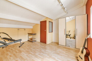 Spacious home office with workout equipment and guitar