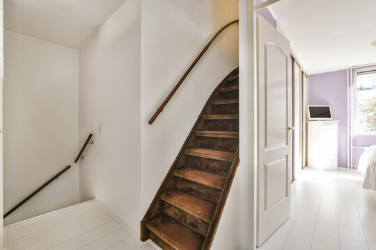 Modern interior with white walls and wooden staircase