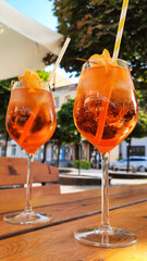 Summer citrus cold cocktail.  Alcoholic Aperol Spritz Cocktail in glass with orange slice on wooden...