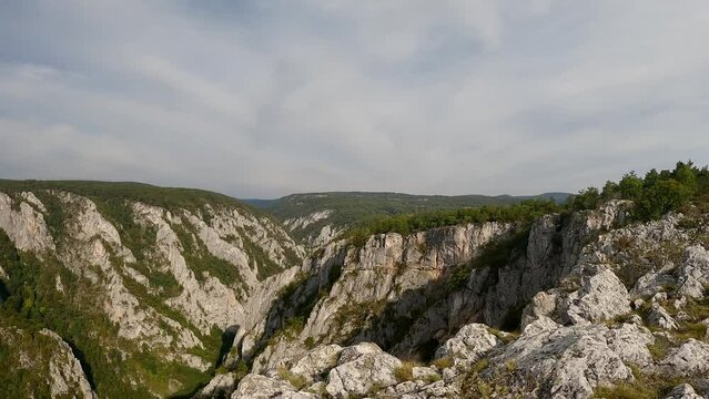 Zadieleska tiesnava valley with steep rocky slopes from Zadielska planina karst plateau in Slovensky kras national park in Slovakia