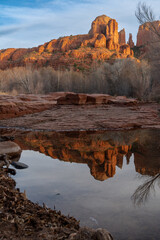 Fototapeta na wymiar Cathedral Rock in Sedona, reflection in Oak Creek. Arizona at sunset