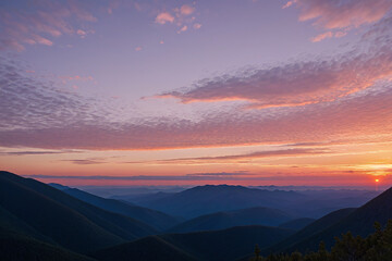 Beautiful sunset sky in the clouds on top of grassy mountains