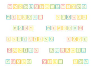 A set of toy blocks spelling out baby themed words
