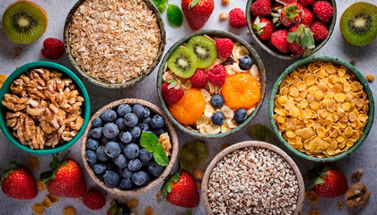 Top view of some bowls with different types of cereals inside and some fresh fruit. The cereal industry and National Cereal Day History. Copy Space.