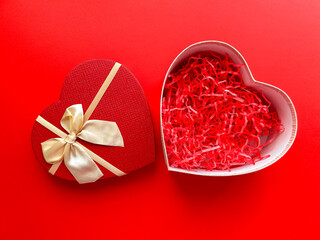 Top view of an open empty heart shaped box on a red background for your products. Happy Valentine's Day, Happy Women's Day, Happy Mother's Day, Happy Birthday