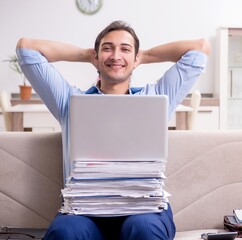 Young male employee working at home
